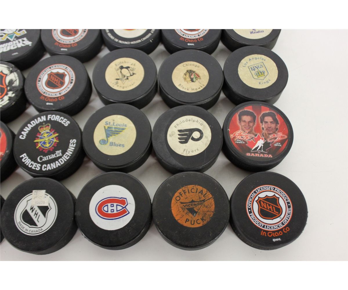 LARGE COLLECTION OF HOCKEY PUCKS large-collection-of-hockey-pucks