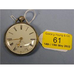 A silver open face pocket watch with white enamel dial, gold hands,  Roman numerals, subsidiary