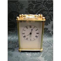 A 20thC.. brass cased carriage timepiece, with ball finials, the  enamelled face with Roman numer