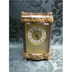 A carriage timepiece, in a shaped brass case with horizontal pierced  scroll banding and scroll h