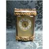 Image 1 : A carriage timepiece, in a shaped brass case with horizontal pierced  scroll banding and scroll h