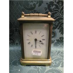 A gong striking carriage clock, in a plain brass case, the enamel  dial with Roman numerals, 4 3/