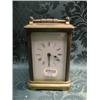 Image 1 : A gong striking carriage clock, in a plain brass case, the enamel  dial with Roman numerals, 4 3/