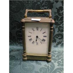 A carriage timepiece, the brass case with corner columns and Roman  numerals to the enamel dial,