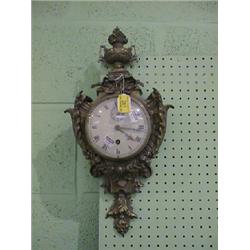 A gilt metal cartel clock, the circular enamel dial with Roman  numerals and seconds dial, the ca