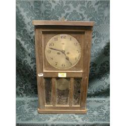 A 1930's oak wall clock with 30 hour movement and 3 bevel glass door,  19 .