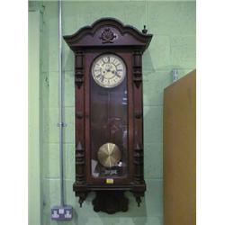 A 19thC. walnut Vienna wall clock with 2 part cream enamel dial (no  pendulum), 48" high.