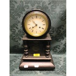 A mid 19thC. French ebonised mantel clock with enamel dial  having Roman numerals and marked Hry.