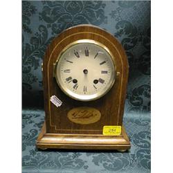 An Edwardian oak mantel clock with shell and string inlaid case,  painted dial with Roman numeral