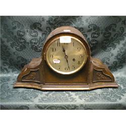 A 1930's Napoleon's hat oak mantel clock with 8-day movement striking  on a gong.