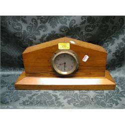 A Smith's 4" console clock, mounted on a pitch pine case as a mantel  clock, 15" wide, 7" high.