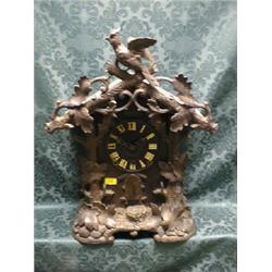 A 19thC. Black Forest mantel clock with traditional rustic and  foliate carved case and having cu