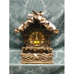 A 19thC. Black Forest mantel clock with vine and berry carved case,  8-day movement striking a go