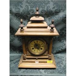 A late 19thC. German walnut mantel clock with moulded stepped top,  simulated enamel and matted 2