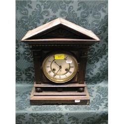 A late 19thC. German oak mantel clock of a lady and architectural  form, having a 2 part enamel d