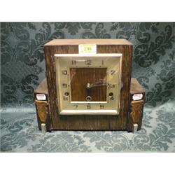 A 1930's Art Deco oak mantel clock with chrome square bezel and  chapter ring, 8-day chiming move