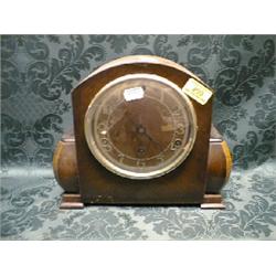A 1930's oak mantel clock with 8-day chiming movement.