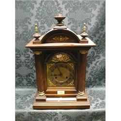A late 19thC. walnut and beech mantel clock of architectural form  having reeded column door, bra