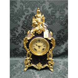 A 19thC. blue slate mantel clock in Louis XV style having gilt  scratch carved decoration to the
