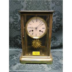 A French gilt brass 4 glass mantel timepiece with white enamel dial  and 8-day movement striking