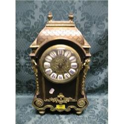 A 19thC. French mahogany and brass mounted mantel clock having  fishscale pagoda top with brass f