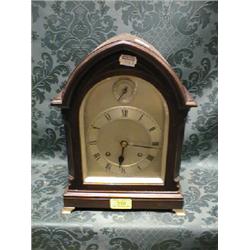 A 20thC.. mahogany bracket clock of arched form with string inlay and  brass bracket feet, silver