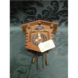 Two miniature cuckoo clocks.