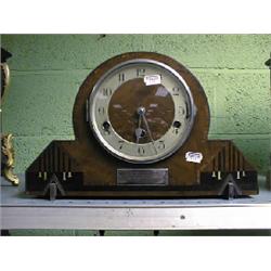 An Art Deco inlaid walnut mantel clock with 8-day chiming movement,  9" high.