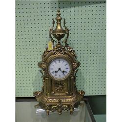 A late 19thC. French gilt metal mantel clock, with a white enamel  circular dial, Roman numerals