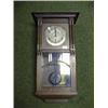Image 1 : A 1920's oak wall clock with 8-day chiming movement.