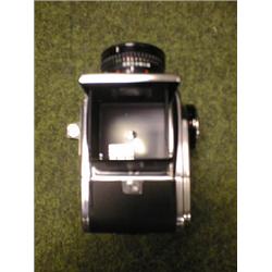 Hasselblad SLR camera with accessories in pigskin case.