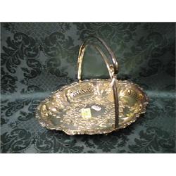 A silver plate fruit basket, pierced and embossed with scrolls,  flowers and foliage, swing handl