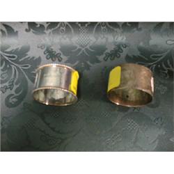 An Edward VII silver napkin ring with gadrooned rims, Birmingham  1908, another, Sheffield 1921.