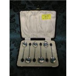 A set of six George V silver coffee spoons with enamelled bowls and  bean finials, Birmingham 192