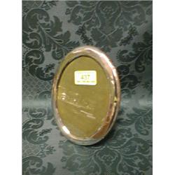 A George V silver photograph frame, oval, with easel stand,  Birmingham 1924, 6 1/2" high.