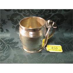 A George III silver barrel shaped mug with reeded bands to the body  and scroll handle, London 18