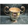 Image 1 : A Victorian silver trophy cup, with double flying scroll handles,  centrally reeded band and on s