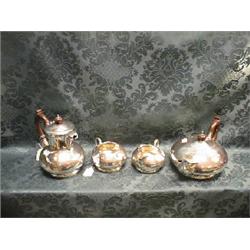 A 4-piece planished silver tea service of compressed circular  outline, the teapot spout moulded