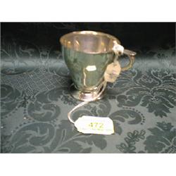 A George V silver bell shaped mug with scroll handle, on circular  foot, London 1911, 3" high.