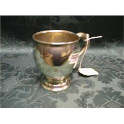 A George V silver ovoid mug, the scroll handle with foliate  thumbpiece, on domed circular foot,