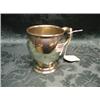 Image 1 : A George V silver ovoid mug, the scroll handle with foliate  thumbpiece, on domed circular foot,