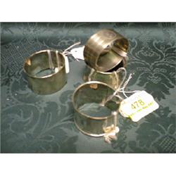 Four silver napkin rings, Sheffield 1879 and 1886, Chester 1911,  Birmingham 1924.
