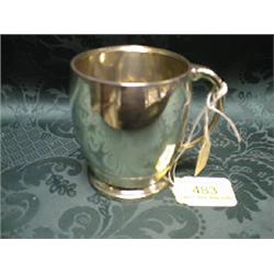 A silver barrel shape mug by Walker & Hall, with loop handle and  lower reeding, Sheffield 1939,