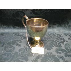 A Victorian silver scroll handled mug, ovoid, engraved with anthemian  and pendant border, on kno