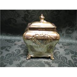An Edward VII silver tea caddy and cover by Walker & Hall, of bombe  form, chased with foliate ca