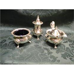 A modern EPNS 3-piece cruet set, each with shell and gadroon cast  rims, on lion mask and claw fe