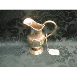 A Victorian silver helmet shape cream jug, Birmingham 1884, with  scroll handle, the half reeded