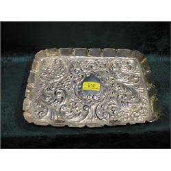 An Edward VII silver dressing table tray, London 1902, oblong,  repousse with scrolls, flowers an