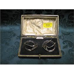 A pair of Edward VII silver clips, modelled as wishbones, on double  ring mounts, Birmingham 1900