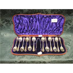 A set of 12 Victorian silver teaspoons and matching tongs by Wm.  Hutton & Sons, having engraved